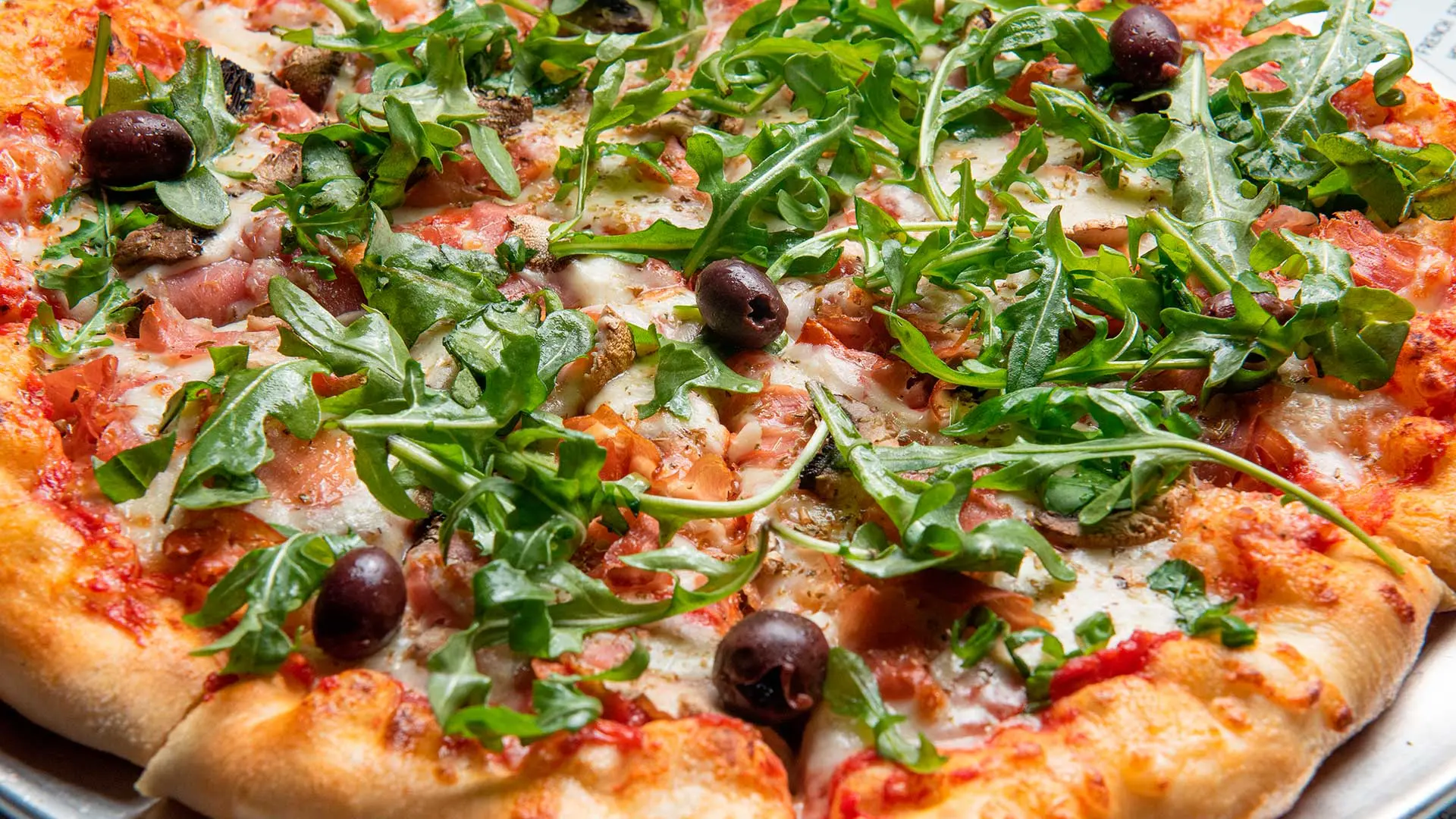 Prosciutto and arugula pizza at Café Korzo